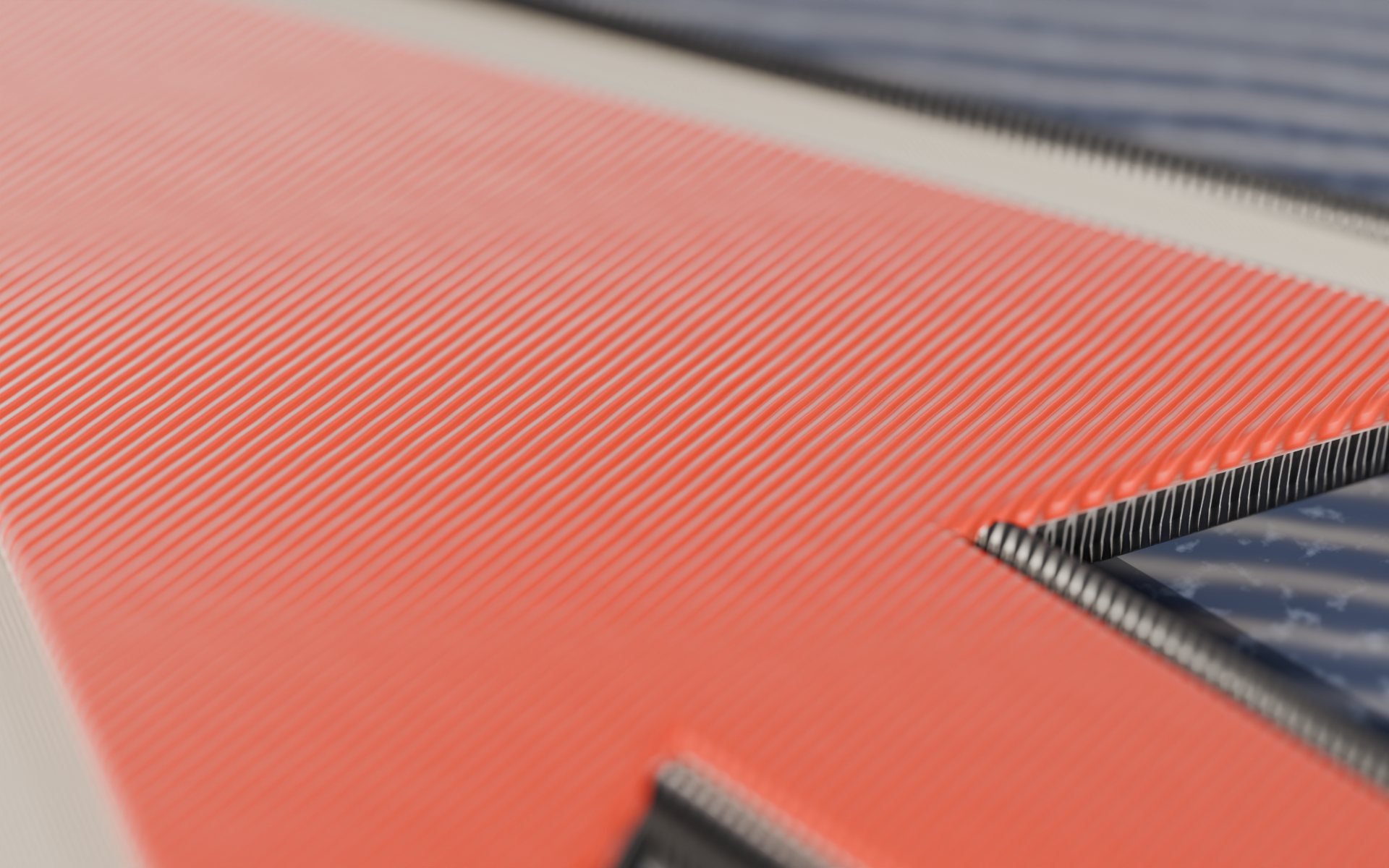 Close-up of the tomato cursor patch: thousands of satin stitches in parallel rows, with the grey merrowed border rolled over the edge.