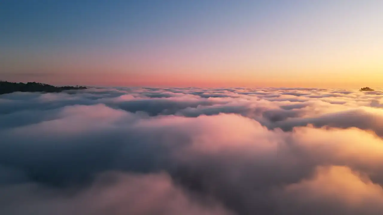 A sea of cloud at sunrise, a ridge just breaking through on the horizon.