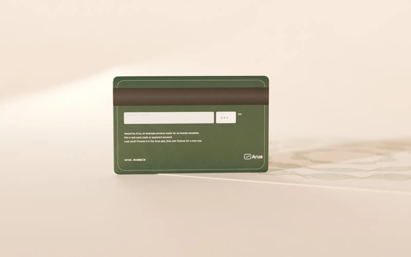 The ink card standing on edge, turned to show its back: signature strip, card security code box and the Arus mark.